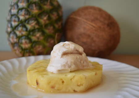 Boozy rotisserie pineapple topped with coconut ice cream - delicious!