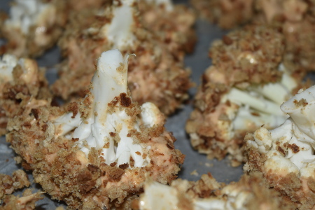 Coating the battered cauliflower in breadcrumbs