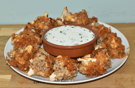 A platter of barbecue buffalo cauliflower wings with the ranch dipping sauce