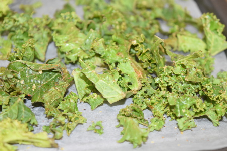 Coating the kale pieces in the tasty seasoning