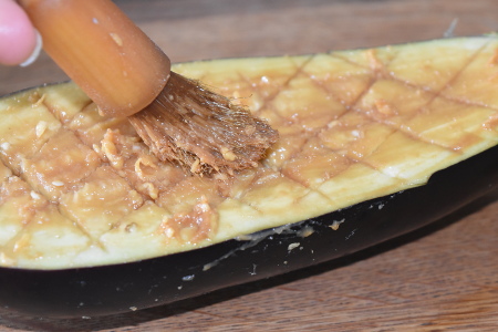 Spreading the marinade onto the aubergine halves