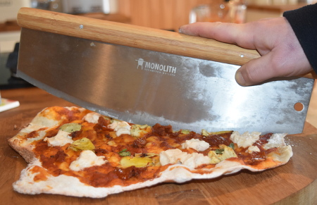 Cutting our vegan barbecue pizza using a Monolith pizza cutter