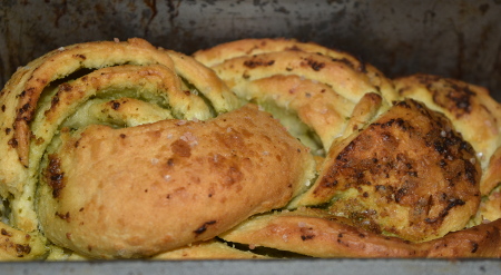 Homemade braided vegan pesto bread, cooked and ready to eat!