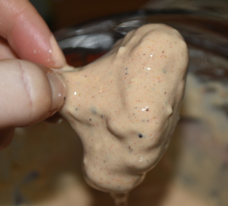 Dipping the cauliflower pieces into the the thick batter